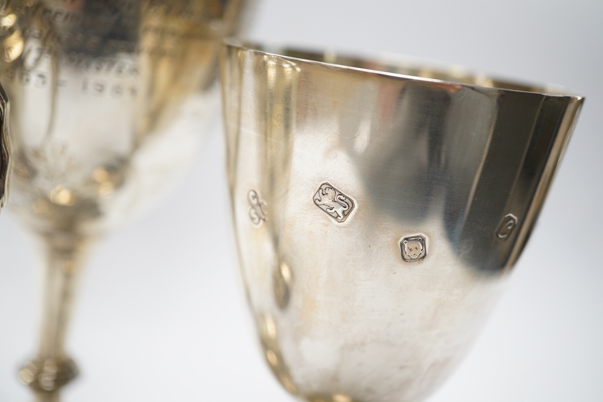 A Victorian engraved silver presentation goblet, with Masonic inscription, London, 1880, 19.5cm, together with a modern silver presentation goblet and a silver two handled presentation trophy cup and cover, 20.2oz. Condi